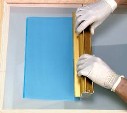 AWT Scoop Coater - Overhead view of Person applying emulsion with Scoop Coater
