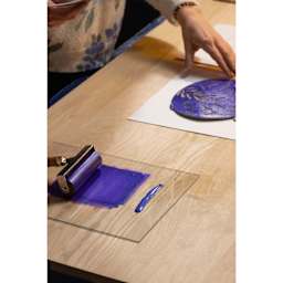 Pebeo Lino Ink - Yellow and Purple Duochrome, 80 ml Tube applied to glass plate and carving with brayer