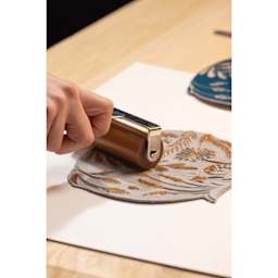 Pebeo Lino Ink - Natural Sienna, 80 ml Tube being applied to carving with brayer