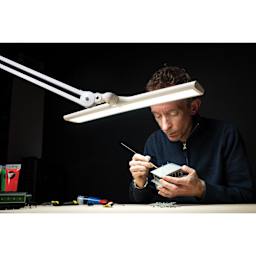Daylight Lumi Task Lamp - White, in use with model building project