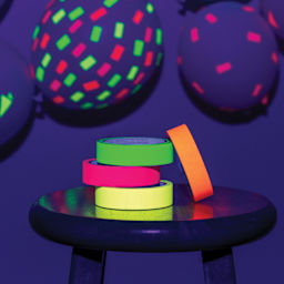 Duck Craft Paper Tapes stacked on table with blacklight