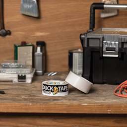 Duck Max Strength Tape - White, 1.88" x 35 yds rolls laying on table