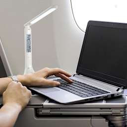 OttLite Travel Rechargeable LED Task Lamp - White, with a laptop