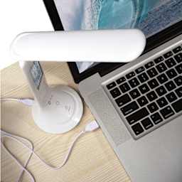 OttLite Travel Rechargeable LED Task Lamp - White, connected to laptop with charging cable
