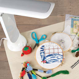 OttLite Dimmable LED Task Lamp - White, with a needlework project