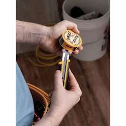 Olfa Pocket-Size Blade Disposal Can, snap blade being inserted into can