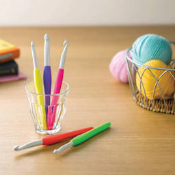 Clover Amour Crochet Hook - M/N, 9mm with other crochet hooks on table top