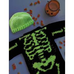 Lion Brand DIY Glow Yarn - laid beanie and skeleton-themed sweater with bones and glowing