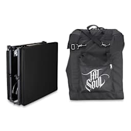 TatSoul X Portable Tattoo Table, folded up next to travel bag