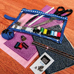 Singer Beginner's Deluxe Sewing Kit pouch and contents with fabric (not included)