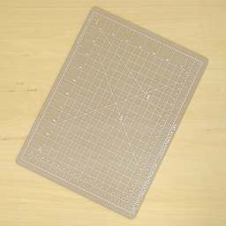 Art Alternatives Self-Healing Cutting Mat - Clear, 9" x 12" laying on table