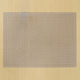 Art Alternatives Self-Healing Cutting Mat - Clear, 18" x 24" laying on table