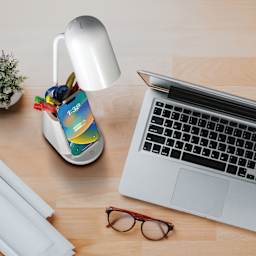 OttLite Aglow Organizer LED Desk Lamp with Wireless Charging - White with a laptop