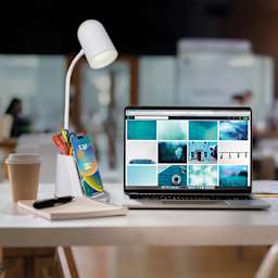 OttLite Aglow Organizer LED Desk Lamp with Wireless Charging - White, on a desk with a computer