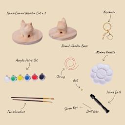 Hand-Carved Wooden Cat x2. Round Wooden Base. Keychain. Acrylic Paint Set. String. Mixing Palette. Paintbrushes. Bell. Screw Eye. Drill Bits. Hand Drill.