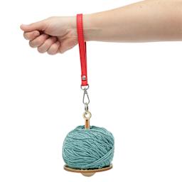 Hemptique Wrist Yarn Holder - Floral holding yarn while hanging from hand