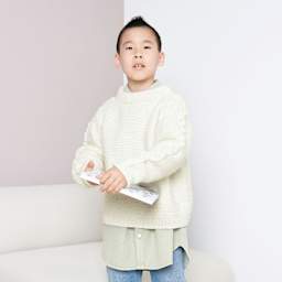 Rico Design Soft Alpaca Yarn - Cream, 137 yds showing completed sweater project being worn