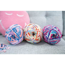Lion Brand Cover Story Favorite Blanket Yarn shoiwng three skeins together