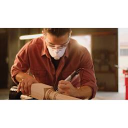 Dremel Wood Accessory Kit - Man using tool and accessory to touch up post