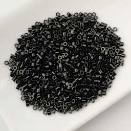John Bead Cylin 11/0 Cylindrical Seed Beads - Black Opaque sitting in dish