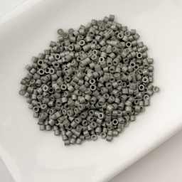 John Bead Cylin 11/0 Cylindrical Seed Beads - Grey Opaque sitting in dish