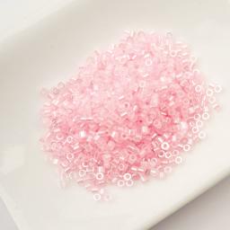 John Bead Cylin 11/0 Ceylon Cylindrical Seed Beads - Light Crystal Pink, 25g sitting in dish