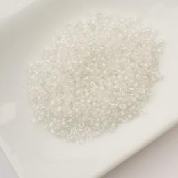 John Bead Cylin 11/0 Glow in the Dark Cylindrical Seed Beads - White to Sky, 25g sitting in dish