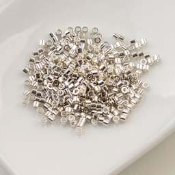 John Bead Cylin 11/0 Cylindrical Seed Beads - Electro Silver sitting in dish