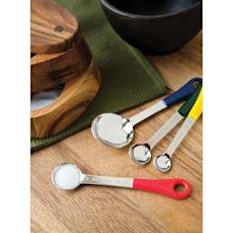 Fox Run Stainless Steel Measuring Spoon Set - Set of 4 strewn on table