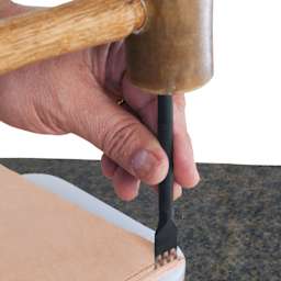 John Bead Metal Complex Leather Lacing Chisel - 4-Prong, Straight, 3.1 mm being used on leather with mallet