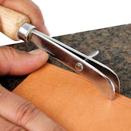 John Bead Metal Complex Adjustable Leather Creaser being used on leather