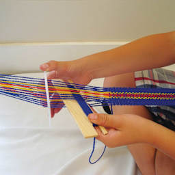 Friendly Loom Backstrap Loom Kit being used to weave included wool warp