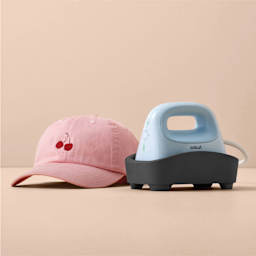 Cricut Hat Press (finished cap next to the press and stand)