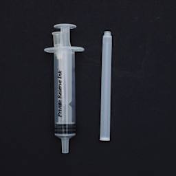 Private Reserve Ink Essentials Long/Magnum Kit 2, a syringe and cartridge against a black background