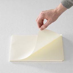 Midori MD Paper Pad - A4, Grid, White, 90 Sheets, sheet being lifted