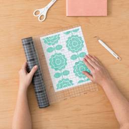 Cricut Linerless Transfer Tape, hand applying tape over print