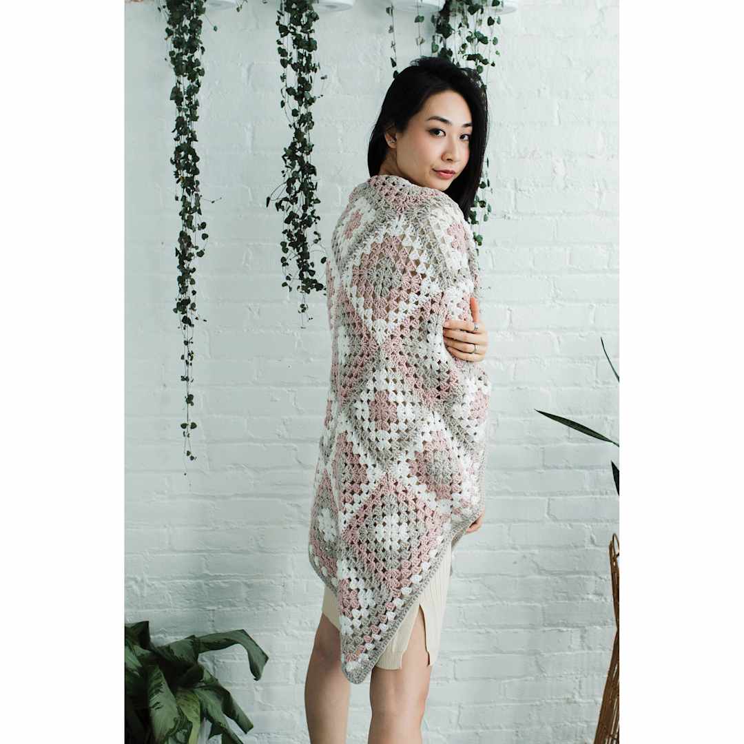 Open in modal - Lion Brand Feels Like Heaven Yarn, adult under blanket made of yarn