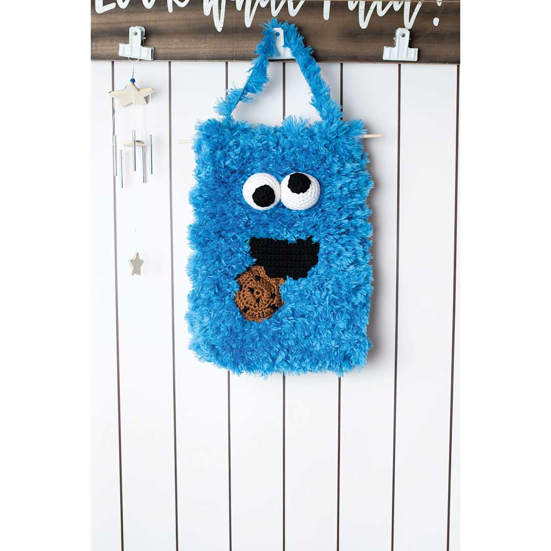 Open in modal - Lion Brand Sesame Street Fuzzy Friend Yarn - Cookie Monster Blue, bag made of yarn