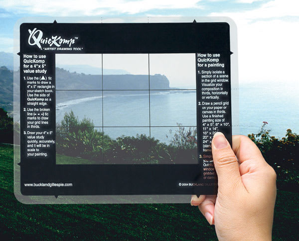 Open in modal - QuicKomp Artist's Drawing Tool - Artist holding Drawing Tool in front of ocean landscape scene