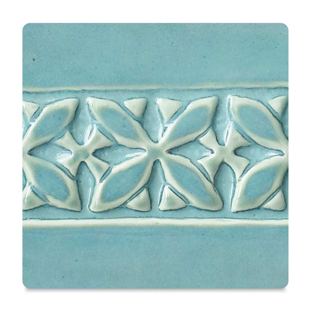 Open in modal - Amaco Potter's Choice Glazes - Blue Lagoon, PC-26. Color sample in blue with cream outlines.