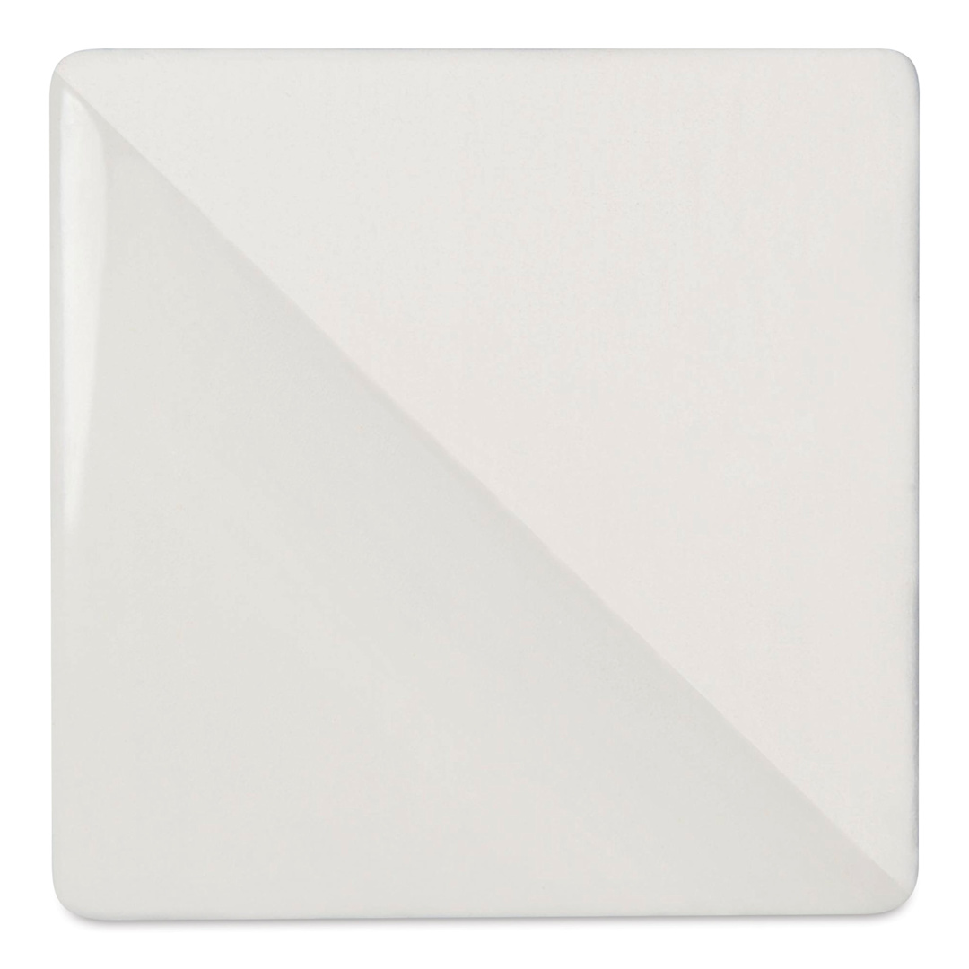 Open in modal - Speedball Ceramic Underglaze - White, Opaque, 2 oz, fired on white clay bisque tiles, half covered in Speedball Clear Glaze, fired to cone 05