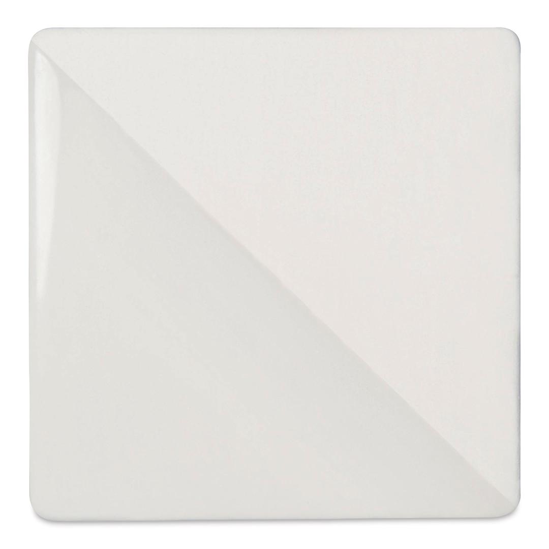 Open in modal - Speedball Ceramic Underglaze - White, Opaque, fired on white clay bisque tiles, half covered in Speedball Clear Glaze, fired to cone 05