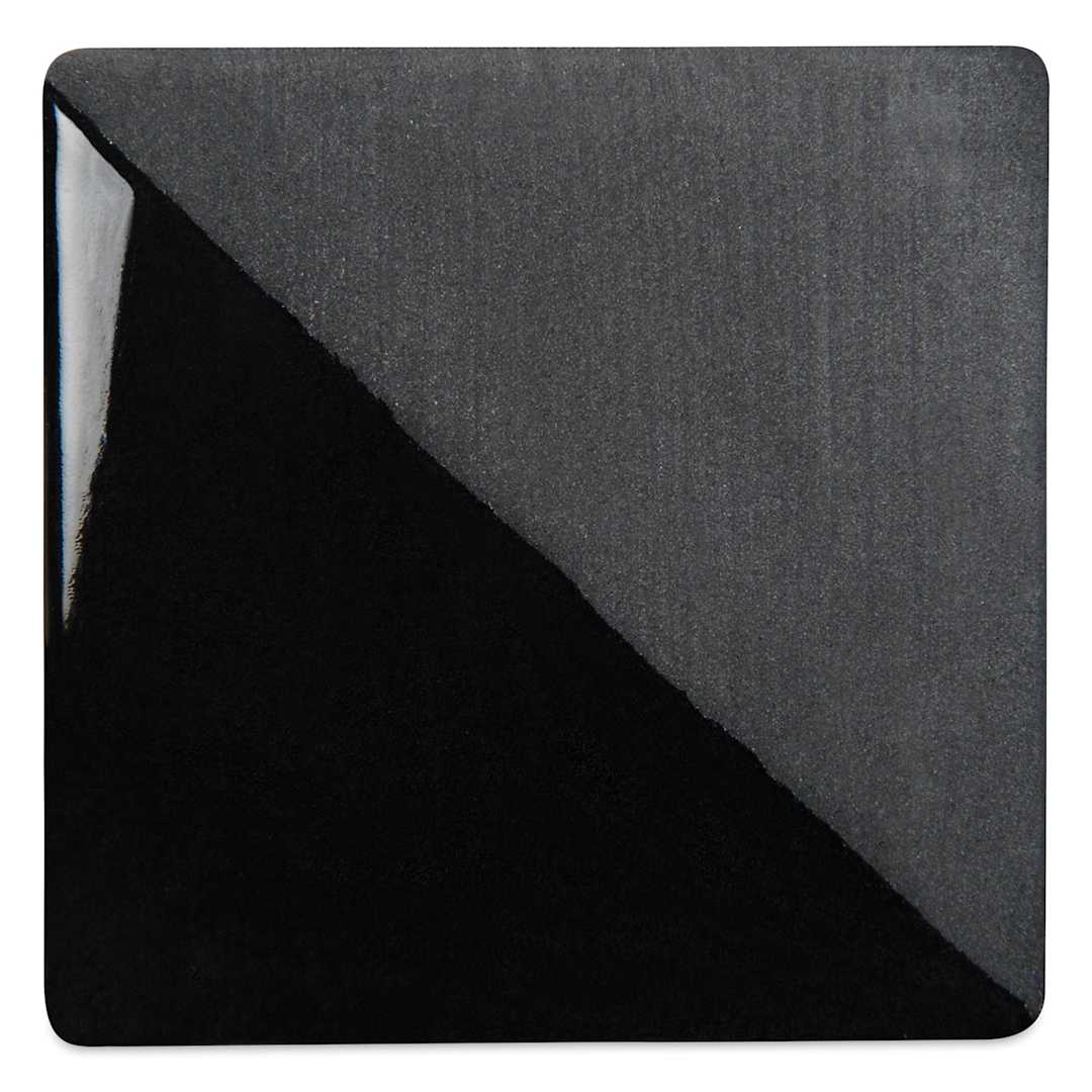 Open in modal - Speedball Ceramic Underglaze - Black, Opaque, fired on white clay bisque tiles, half covered in Speedball Clear Glaze, fired to cone 05