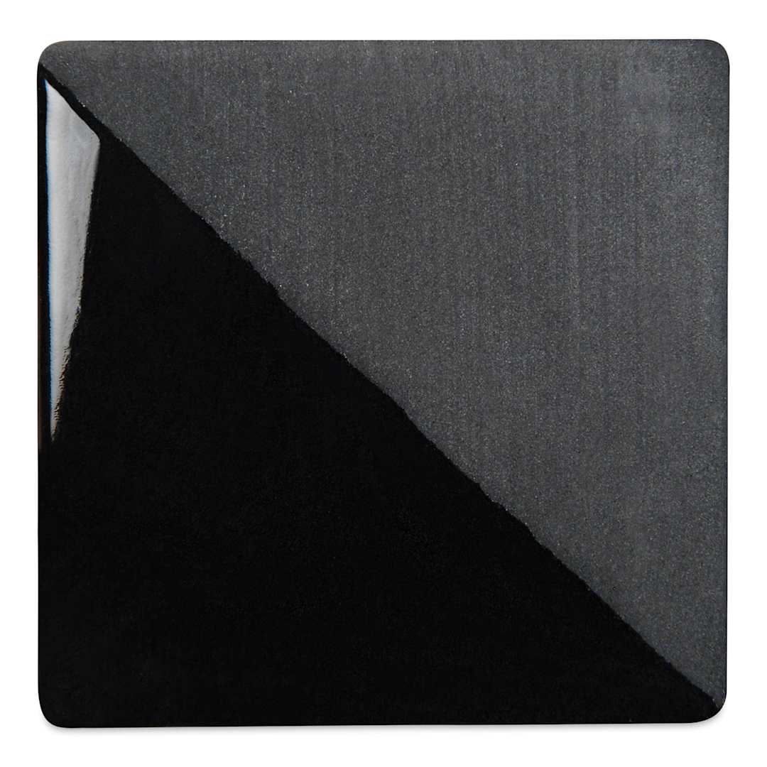 Open in modal - Speedball Ceramic Underglaze - Black, Opaque, fired on white clay bisque tiles, half covered in Speedball Clear Glaze, fired to cone 05