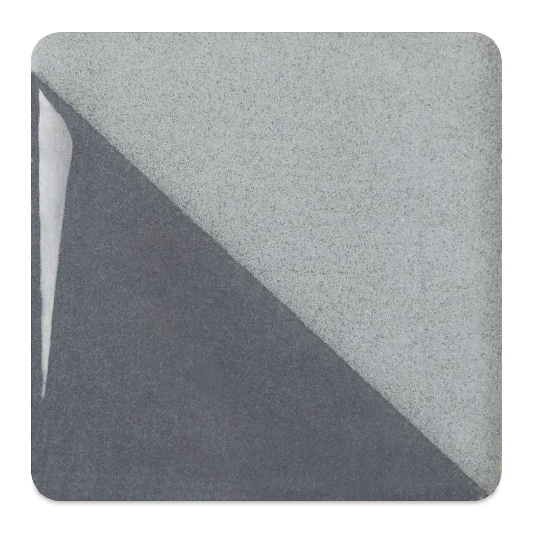 Open in modal - Speedball Ceramic Underglaze - Cool Gray, fired on white clay bisque tiles, half covered in Speedball Clear Glaze, fired to cone 05