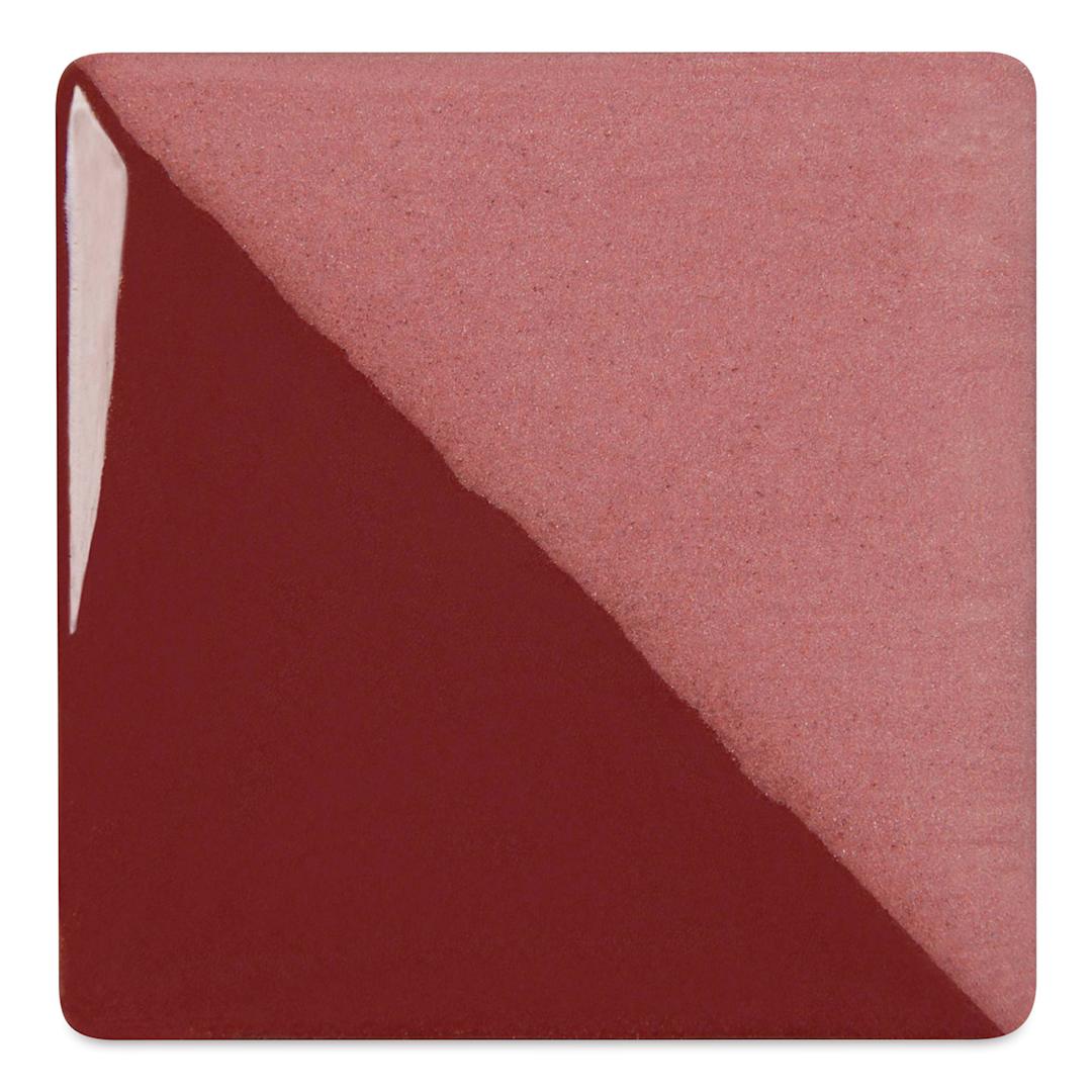 Open in modal - Speedball Ceramic Underglaze - Burgundy, Opaque, fired on white clay bisque tiles, half covered in Speedball Clear Glaze, fired to cone 05