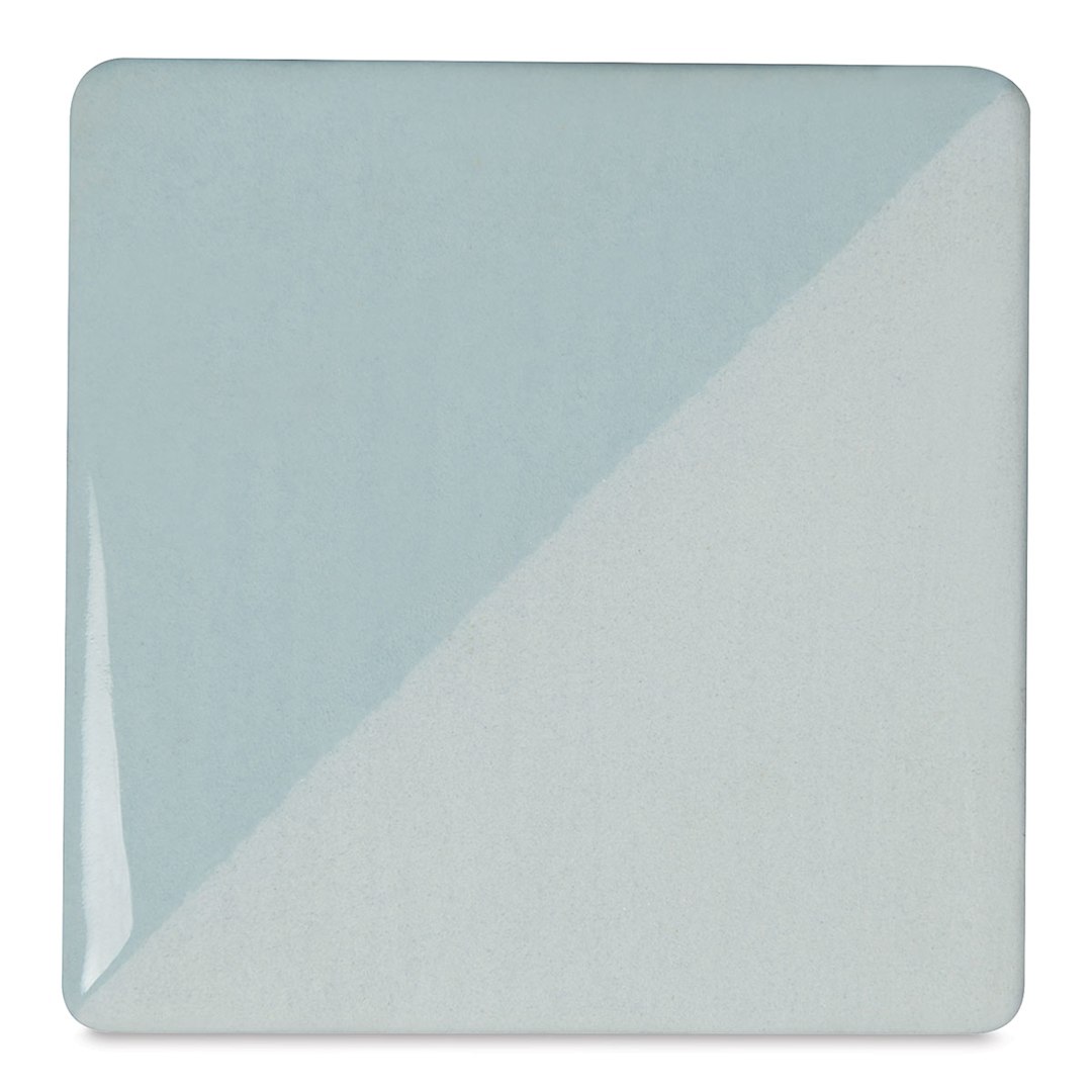 Open in modal - Speedball Ceramic Underglaze - Blue Frost, Opaque, fired on white clay bisque tiles, half covered in Speedball Clear Glaze, fired to cone 05