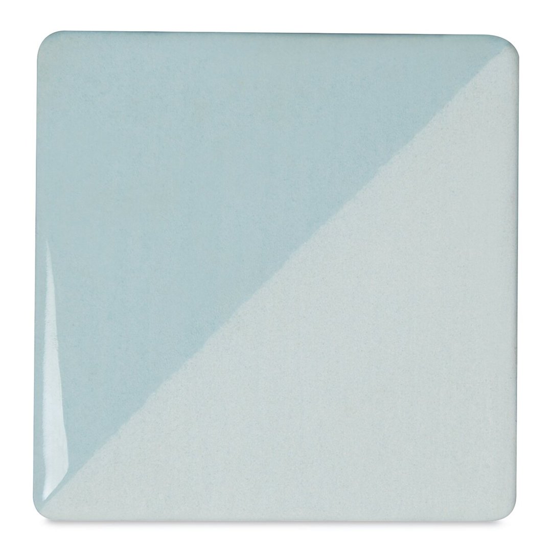 Open in modal - Speedball Ceramic Underglaze - Blue Frost, Opaque, fired on white clay bisque tiles, half covered in Speedball Clear Glaze, fired to cone 05