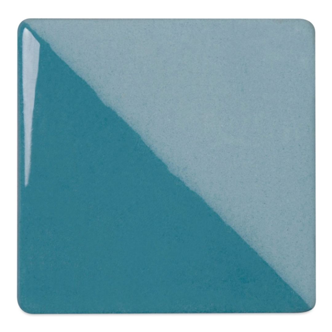 Open in modal - Speedball Ceramic Underglaze - Turquoise, Opaque, fired on white clay bisque tiles, half covered in Speedball Clear Glaze, fired to cone 05