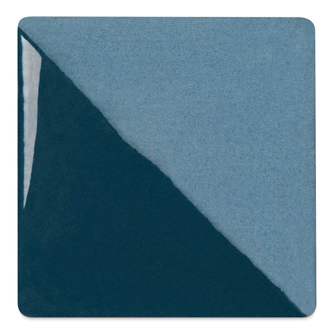 Open in modal - Speedball Ceramic Underglaze - Sea Blue, Opaque, fired on white clay bisque tiles, half covered in Speedball Clear Glaze, fired to cone 05